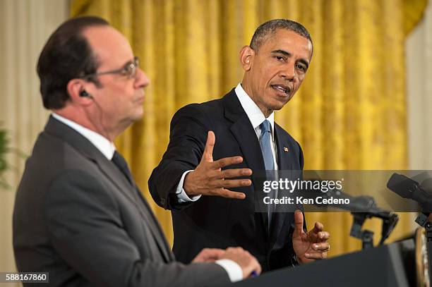 President Barack Obama answers reporters questions during a news conference with French President Francois Hollande in the East Room after a...