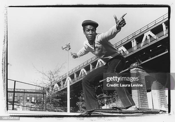 And producer Grandmaster Flash poses for a portrait under the Manhattan Bridge in 1981 in Brooklyn, New York.