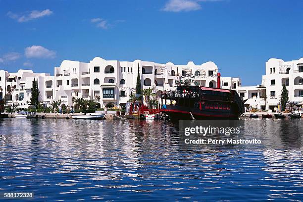 boats passing hotels at port - tunisia hotel stock pictures, royalty-free photos & images