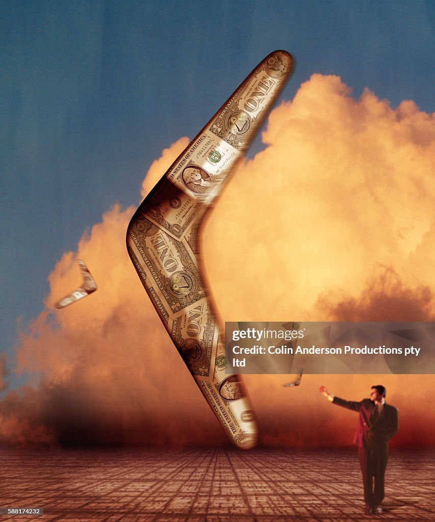 Businessman Preparing to Catch a Boomerang