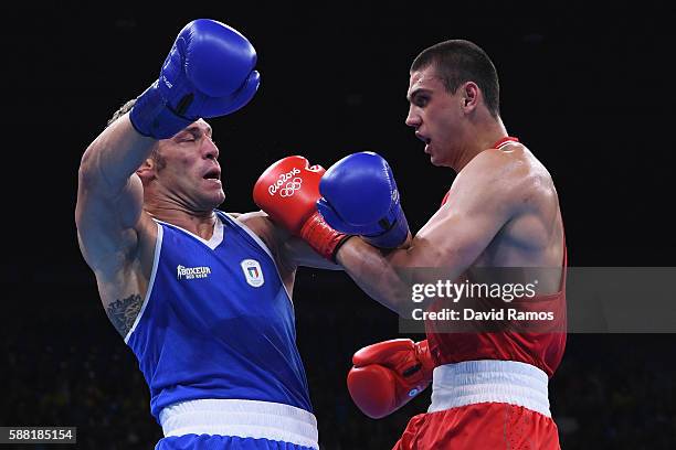 Evgeny Tishchenko of Russia and Clemente Russo of Italy compete in the Men's Heavy quarterfinals round fight on Day 5 of the Rio 2016 Olympic Games...