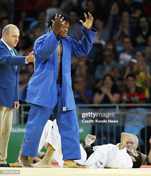 Popole Misenga, a refugee from the Democratic Republic of the Congo living in Brazil, celebrates after defeating India's Avtar Singh during a men's...