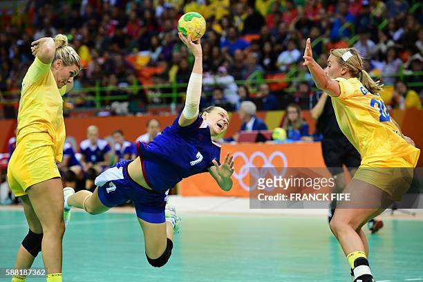 Russia's centre back Daria Dmitrieva jumps to shoot past Sweden's centre back Isabelle Gullden during the women's preliminaries Group A handball...