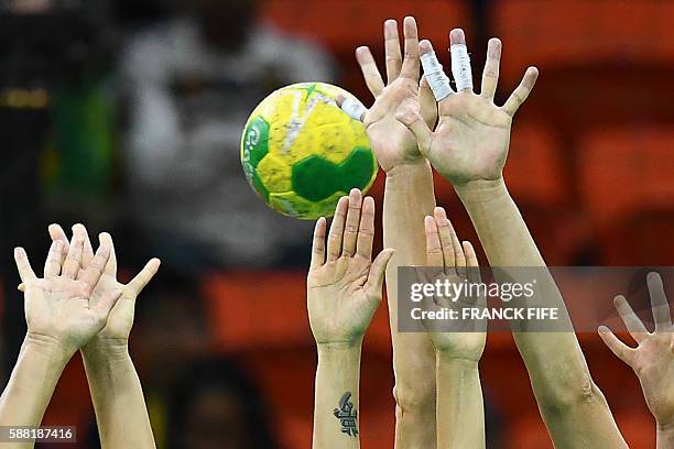 Russian defenders try to stop a free-throw shot during the women's preliminaries Group B handball match Russia vs Sweden for the Rio 2016 Olympics...