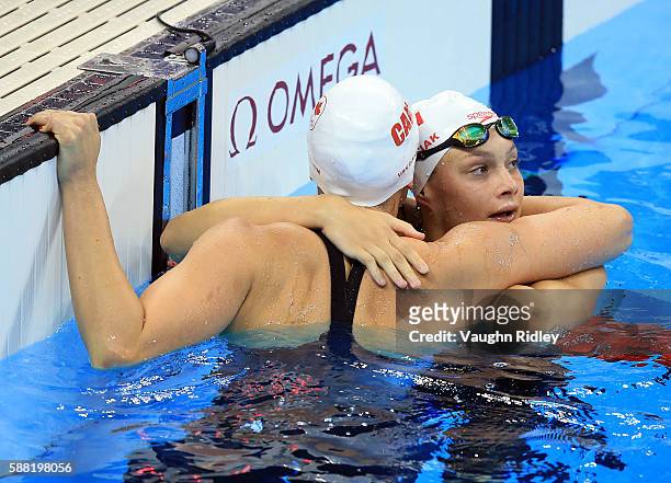 Chantel Van Landeghem and Penny Oleksiak of Canada embrace following the Women's 100m Freestyle Heats on Day 5 of the Rio 2016 Olympic Games at the...