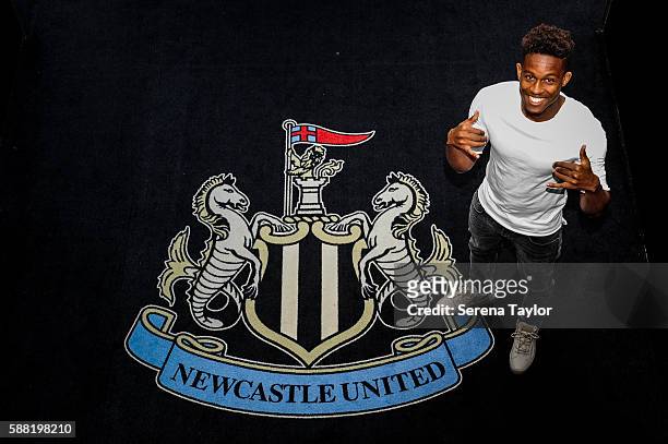 Rolando Aarons poses for photographs with the club crest after signing a new 5 year contract for Newcastle United at St.James Park on August 10 in...