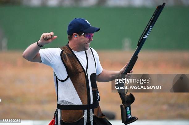 Bronze medal winner, Britain's Steve Scott, celebrates during the men's double trap final at the Rio 2016 Olympic Games at the Olympic Shooting...