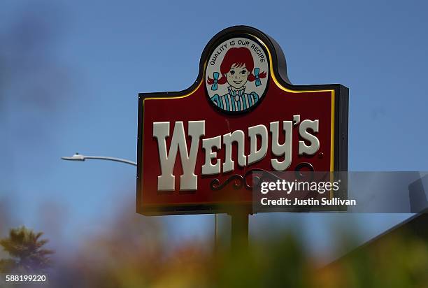 Sign is posted in front of a Wendy's restaurant on August 10, 2016 in Daly City, California. Wendy's reported a 22% decline in second quarter...