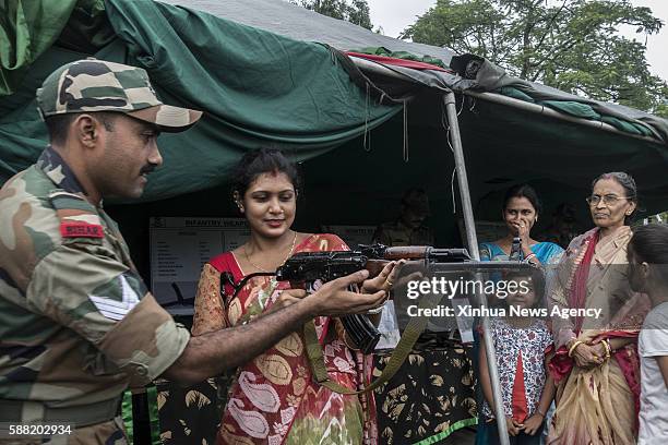 Aug. 10, 2016-- An Indian woman tries a weapon during a "Know Your Army" exhibition in Kolkata, capital of eastern Indian state West Bengal, Aug. 10,...