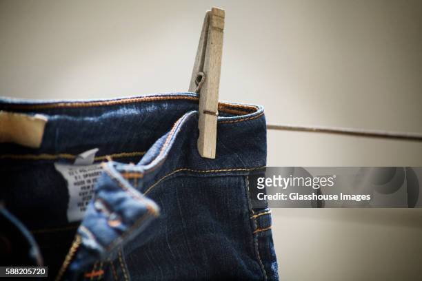 blue jeans on clothes line detail - jeans label stock pictures, royalty-free photos & images