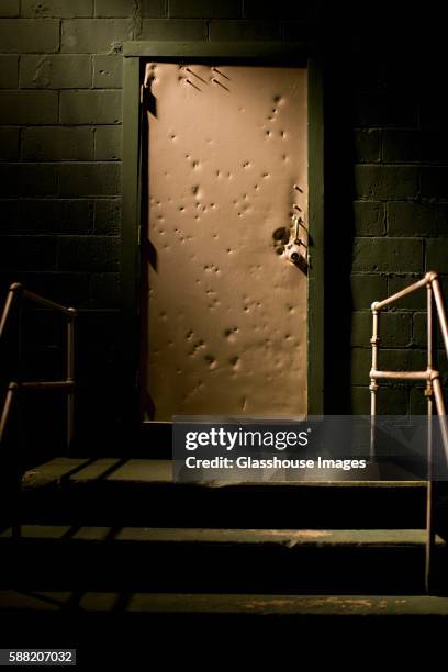 dented door and stairs in shadows - horror metal stock pictures, royalty-free photos & images