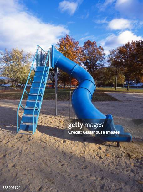 blue slide in playground - slide stock-fotos und bilder