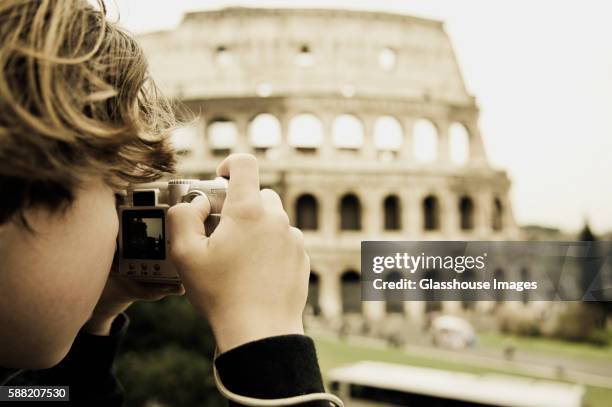 teen boy taking photo of colosseum, rome, italy - digital camera stock pictures, royalty-free photos & images