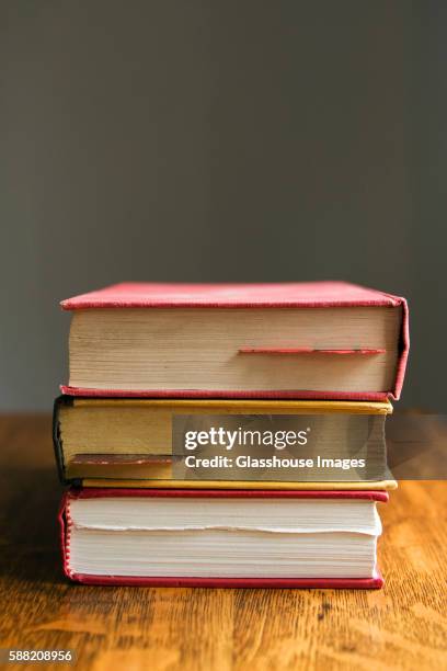 three stacked hardcover books - segnalibro foto e immagini stock