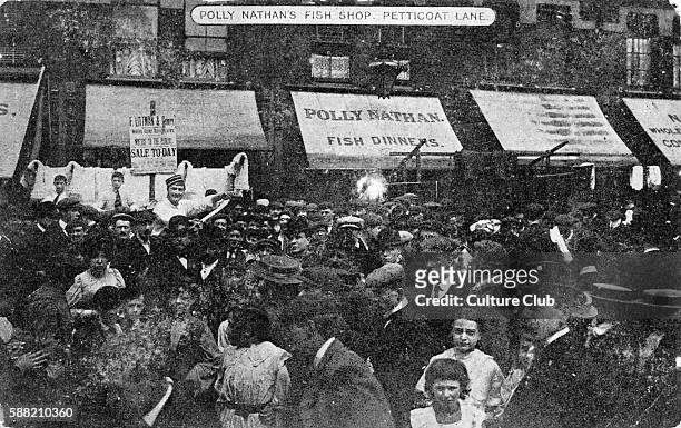 Petticoat Lane Market, c. 1909. View of Polly Nathan s fish shop and street full of people.