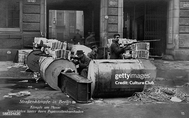 Street battles in Berlin - Spartacists behind a paper roll barricade. During Spartacist Uprising of German Revolution of November 1918 Spartacus...