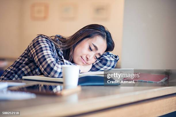 fall asleep during studying - woman sleeping table stock pictures, royalty-free photos & images