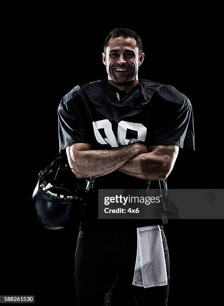 smiling football player standing - american football player isolated stock pictures, royalty-free photos & images