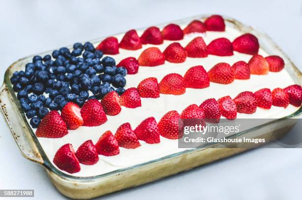 american flag cake decorated with blueberries and strawberries - cake flag stock pictures, royalty-free photos & images