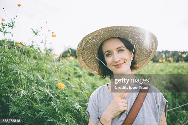 portrait of woman with straw hat - straw hat stock pictures, royalty-free photos & images