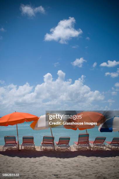 chairs and umbrellas on beach, st. maarten, dwi - isla de san martín fotografías e imágenes de stock