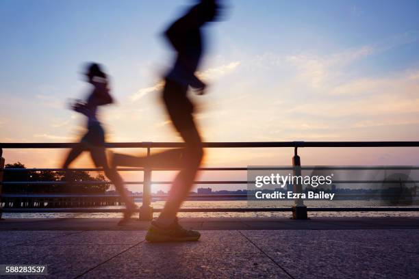 runners on an early morning jog in the city. - blurred motion bildbanksfoton och bilder