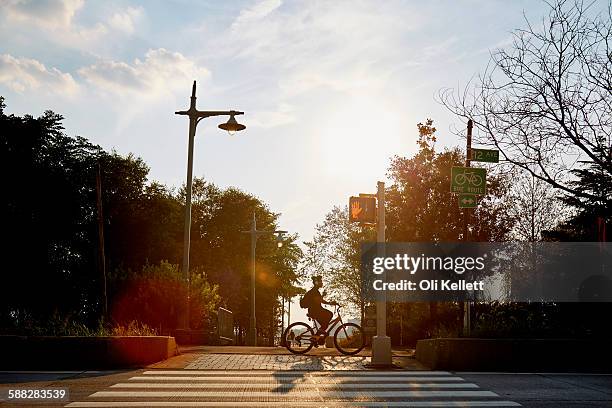 commuter cycling to work in the morning. - bicycle safety light stock pictures, royalty-free photos & images