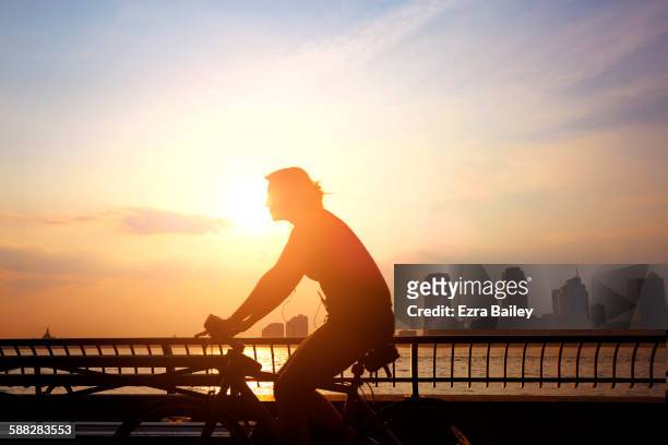 commuter cycling to work in the morning. - sunrise dawn stock pictures, royalty-free photos & images