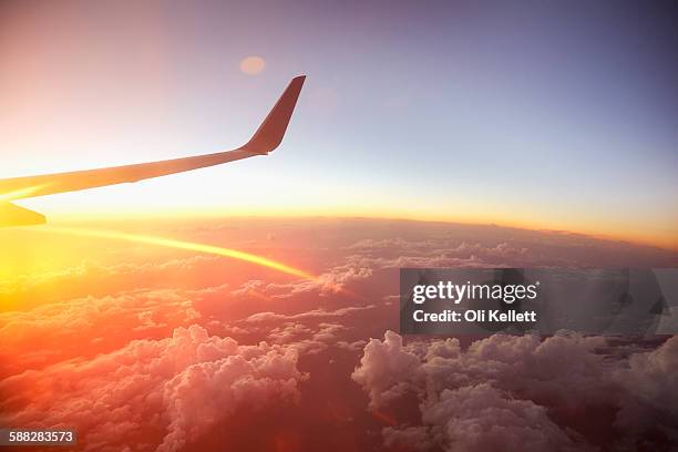 sunrise over the world from a plane window. - flyby fotografías e imágenes de stock