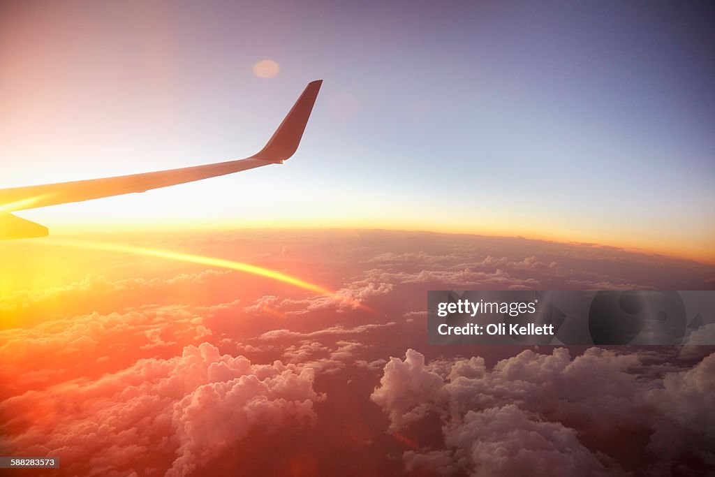 Sunrise over the world from a plane window.