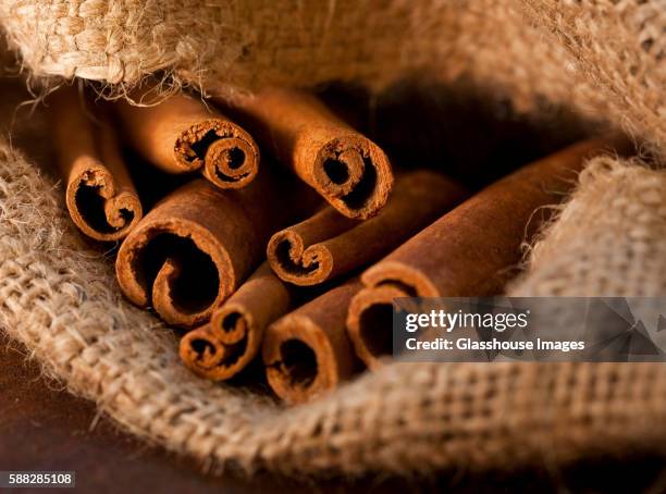 cinnamon sticks in burlap sack, close-up - cinnamon stock pictures, royalty-free photos & images