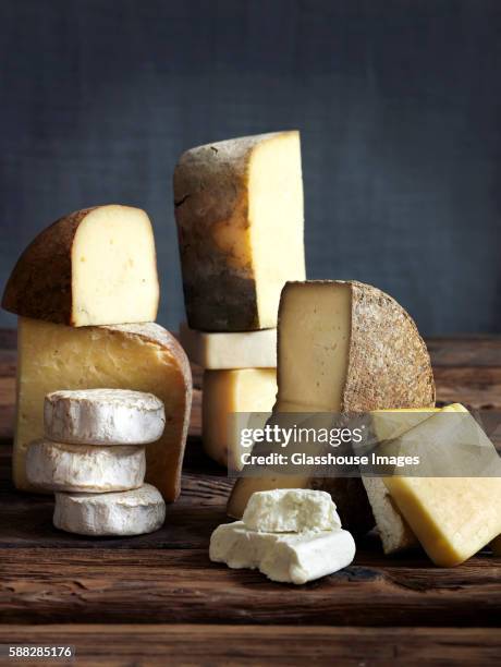 cheese still life on boards - cheeses stock-fotos und bilder