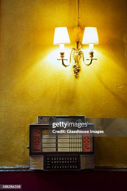 old jukebox on yellow wall - vintage record player no people ストックフォトと画像