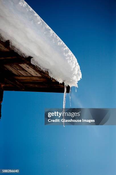 melting icicle and snow on roof, halsingland, sweden - icicle stock pictures, royalty-free photos & images