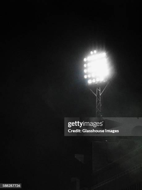 stadium floodlight on foggy night - stadium light stock pictures, royalty-free photos & images