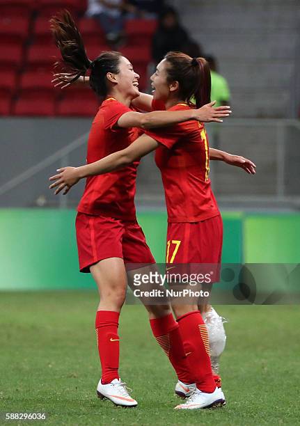 Chinese player Wu Haiyan hugs with her teammate Gu yasha during the women's group E football match between China and Sweden at the 2016 Olympic...