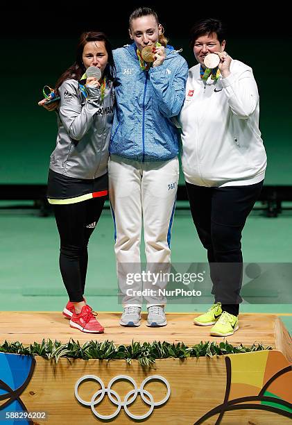 Gold medalist Anna Korakaki of Greece, silver medalist Monika Karsch of Germany and bronze medalist Heidi Diethelm Gerber of Switzerland show their...