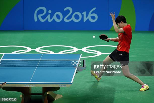 Li Xiaoxia of China returns the ball during the women's singles quarterfinal of table tennis between Li Xiaoxia of Chian and Cheng I-Ching of Chinese...