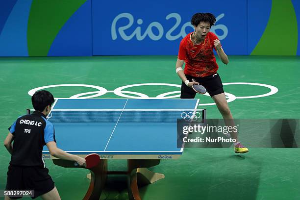 Li Xiaoxia of China celebrates scoring during the women's singles quarterfinal of table tennis between Li Xiaoxia of Chian and Cheng I-Ching of...