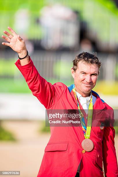 Phillip Dutton of the United States celebrates at the awarding ceremony of the equestrian eventing individual competition at the 2016 Rio Olympic...