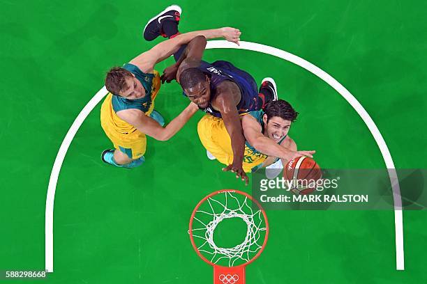 An overview shows Australia's guard Damian Martin and USA's guard Kevin Durant go for a rebound during a Men's round Group A basketball match between...