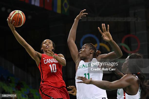 Nirra Fields of Canada puts up a shot in front of Maimouna Diarra of Senegal in the Women's Basketball Preliminary Round Group B match between Canada...