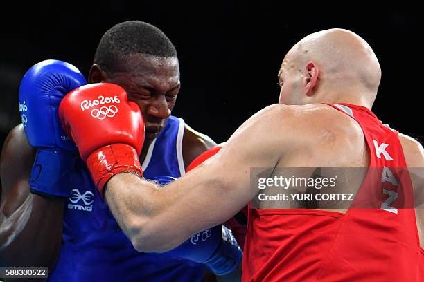 Kazakhstan's Vassiliy Levit punches Mauritius' Kennedy St Pierre during the Men's Heavy Quarterfinal 3 match at the Rio 2016 Olympic Games at the...