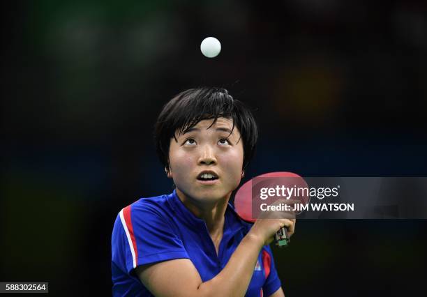 North Korea's Kim Song I eyes the ball as she serves against Japan's Ai Fukuhara in their women's singles bronze medal table tennis match at the...