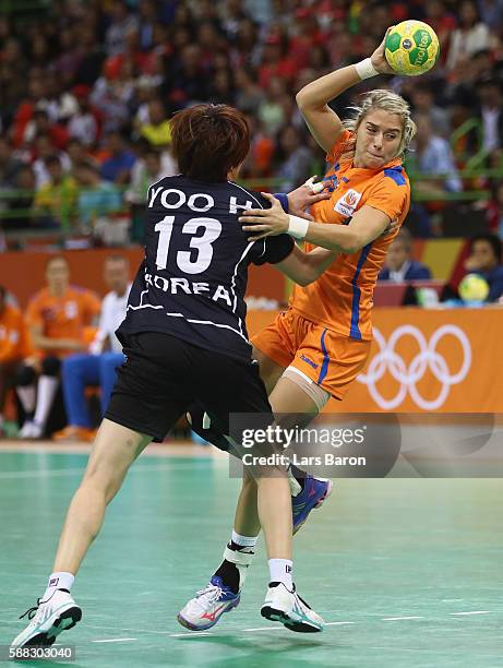 Hyunji Yoo of Korea challenges Estavana Polman of Netherlands during the Womens Preliminary Group A match between Norway and Angola at Future Arena...