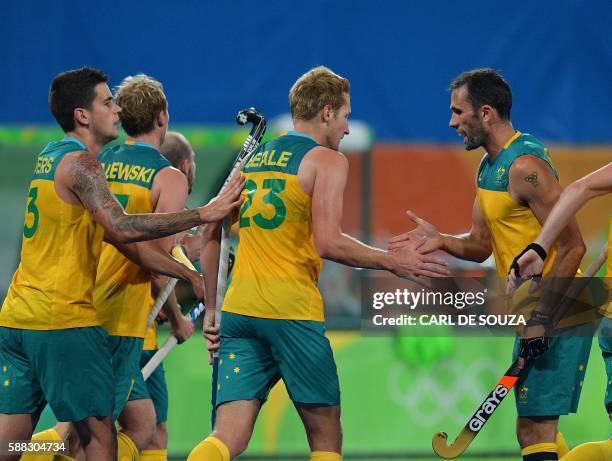 Australia's Daniel Beale celebrates a goal with teammate Mark Knowles during the men's field hockey Britain vs Australia match of the Rio 2016...