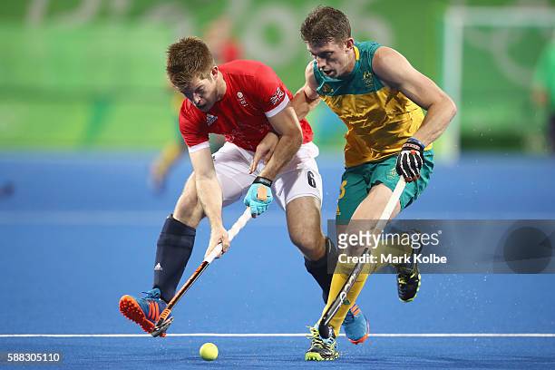 Henry Weir of Great Britain and Simon Orchard of Australia compete for the ball during the men's pool A match between Great Britain and Australia on...
