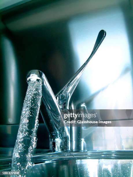 water pouring out of kitchen faucet - running water faucet stock pictures, royalty-free photos & images