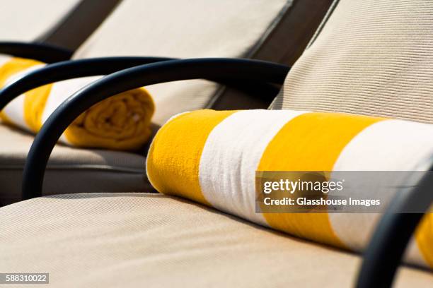 rolled up beach towels on lounge chairs - striped towel stock pictures, royalty-free photos & images