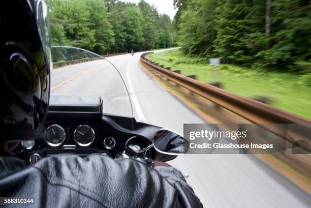 motorcycle and rider on scenic road - motorcycle handle stock pictures, royalty-free photos & images